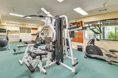 a gym with treadmills and elliptical machines at Peaceful Escape in the Pines Arnold Cabin with Deck in Arnold