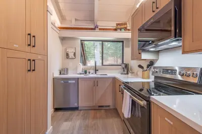 a kitchen with a sink and a stove top oven at Northstar Nest in Truckee