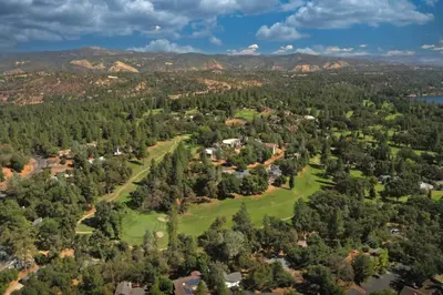 an aerial view of a golf course in the mountains at StayCation Sierra – Nonpareil Retreat in Groveland