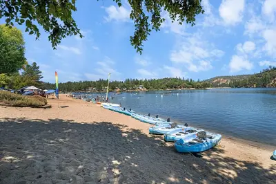 a row of boats on the shore of a lake at Peaceful Pines Escape Near Yosemite, Lake & Golf in Groveland