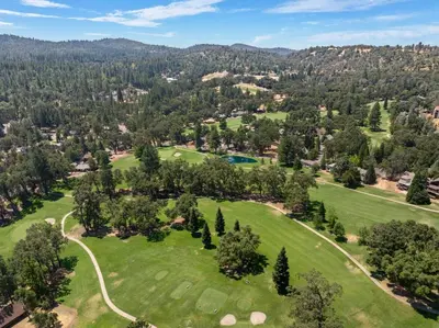 an aerial view of a golf course with trees at Peaceful Pines Escape Near Yosemite, Lake & Golf in Groveland