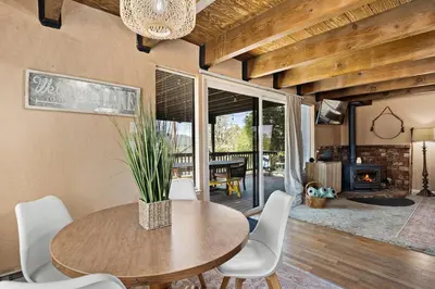 a dining room with a table and chairs and a fireplace at Peaceful Pines Escape Near Yosemite, Lake & Golf in Groveland