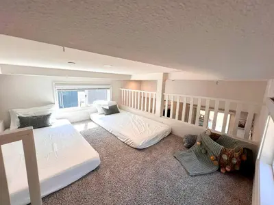 a bedroom with two beds and a staircase at Bright Modern Tiny Retreat with Yoga Dome Near Yosemite, Groveland, California in Groveland