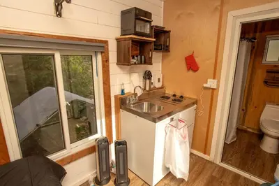 a tiny kitchen with a sink and a toilet at Cozy Modern Tiny Retreat with Stargazing & Yoga Dome Access Near Yosemite Tioga Pass, Groveland, California in Groveland