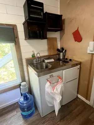 a small kitchen with a sink and a sink at Cozy Modern Tiny Retreat with Stargazing & Yoga Dome Access Near Yosemite Tioga Pass, Groveland, California in Groveland