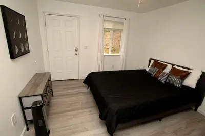 a bedroom with a black bed and a table at Cozy Nature-Filled Home with Garden & Night Sky Views Near Yosemite Tioga Pass, Groveland CA in Groveland