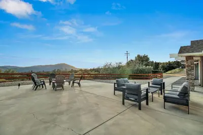 a group of chairs and tables on a patio at Twilight Villa,Hot Tub,EV Charger,Yosemite and Bass lake in Oakhurst