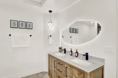 a bathroom with a sink and a mirror at Twilight Villa,Hot Tub,EV Charger,Yosemite and Bass lake in Oakhurst