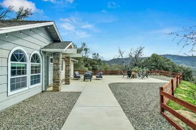 a house with a fence and a patio at Twilight Villa,Hot Tub,EV Charger,Yosemite and Bass lake in Oakhurst