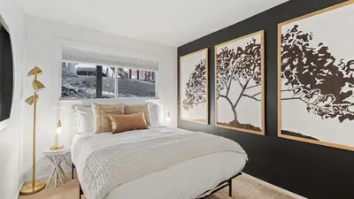 a bedroom with a white bed and pictures on the wall at Les Roes by AvantStay Incline Village Retreat • Near Lake Tahoe Beaches and Scenic Trails Diamond Peak and Local Hot Spots in Incline Village