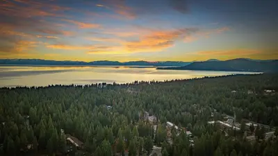 an aerial view of a lake with trees at Les Roes by AvantStay Incline Village Retreat • Near Lake Tahoe Beaches and Scenic Trails Diamond Peak and Local Hot Spots in Incline Village