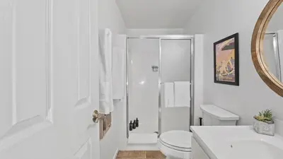 a white bathroom with a toilet and a sink at Les Roes by AvantStay Incline Village Retreat • Near Lake Tahoe Beaches and Scenic Trails Diamond Peak and Local Hot Spots in Incline Village