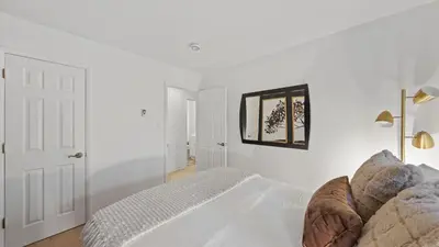 a white bedroom with a bed and a mirror at Les Roes by AvantStay Incline Village Retreat • Near Lake Tahoe Beaches and Scenic Trails Diamond Peak and Local Hot Spots in Incline Village