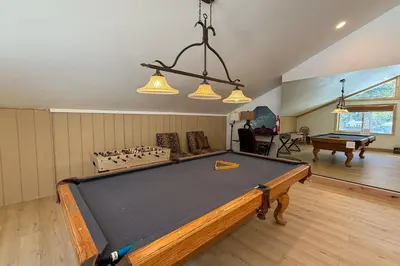 a living room with a pool table in it at Lazy Bear Manor in South Lake Tahoe