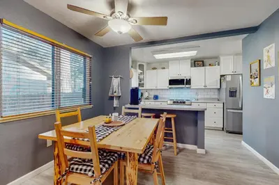 a kitchen with a table and chairs and a ceiling fan at Whispering Pines Retreat in South Lake Tahoe