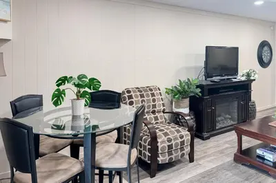 a dining room with a table and chairs and a tv at Lakeview Gem in South Lake Tahoe