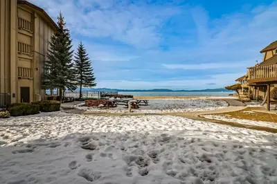 a beach covered in snow in front of buildings at Lakeview Gem in South Lake Tahoe