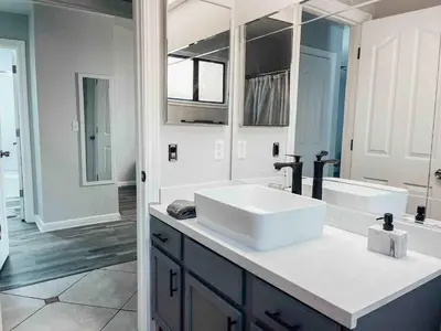 a white bathroom with a sink and a tub at Cozy 2 bedroom 2 baths home in North Highlands