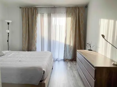 a bedroom with a bed and a dresser and a window at Cozy 2 bedroom 2 baths home in North Highlands