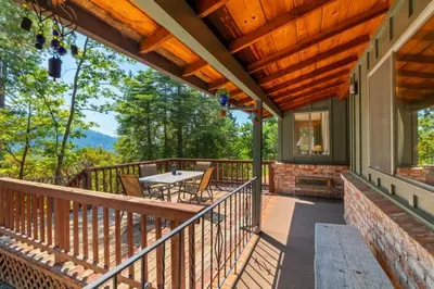 a balcony with a table and chairs on it at Mountain View House in Mi-Wuk Village
