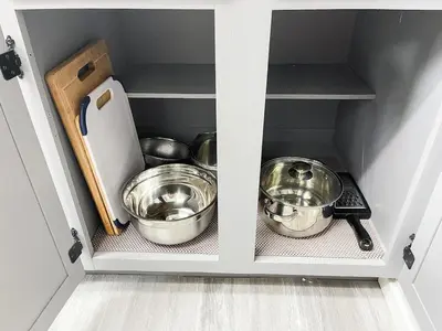a cabinet with two bowls and pans in it at Beautiful 2 bedroom 2 bathroom house in North Highlands