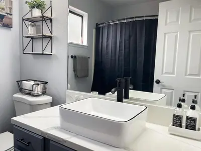 a white bathroom with a sink and a toilet at Beautiful 2 bedroom 2 bathroom house in North Highlands