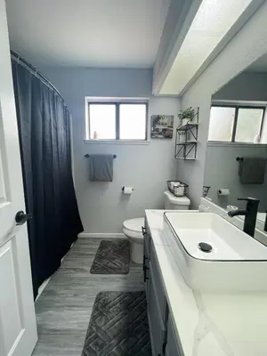 a bathroom with a sink and a toilet and a window at Beautiful 2 bedroom 2 bathroom house in North Highlands