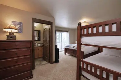 a bedroom with two bunk beds and a mirror at Kirkwood Mountainside Cabin Views Walk to Lifts in Kirkwood