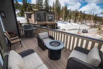 a deck with chairs and a grill on a house at Kirkwood Mountainside Cabin & Cottage Deck wViews in Kirkwood