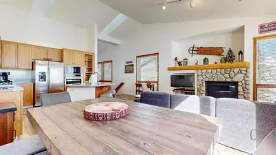 a kitchen and dining room with a wooden table in a room at Snowcreek V #777 condo in Mammoth Lakes