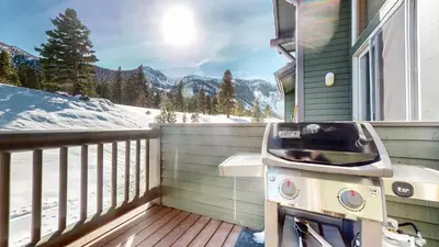 a grill on a balcony with a view of the mountains at Snowcreek V #777 condo in Mammoth Lakes