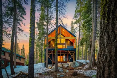 a house in the woods with trees at Donner Summit - Hot Tub, Fireplace & Mountain Views in Soda Springs