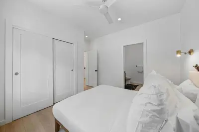 a white bedroom with a white bed and two closets at Donner Summit - Hot Tub, Fireplace & Mountain Views in Soda Springs