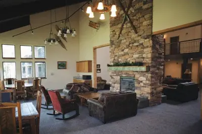 a large living room with a stone fireplace at The Meadows-Cozy Family Condo in Kirkwood Deck in Kirkwood
