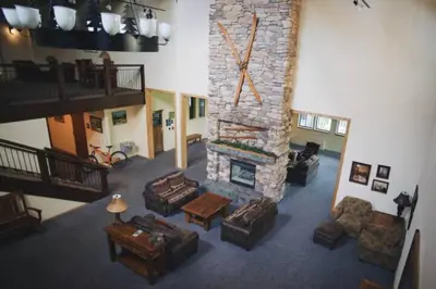 a living room with a stone fireplace with couches at The Meadows-Cozy Hotel Room Deck in Kirkwood