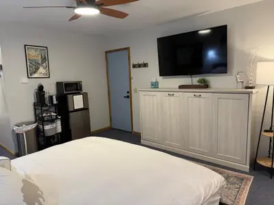 a bedroom with a flat screen tv on the wall at The Meadows- Charmed Hotel Unit Steps to Ski Lifts in Kirkwood