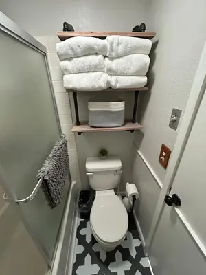 a small bathroom with a toilet and some towels at The Meadows- Charmed Hotel Unit Steps to Ski Lifts in Kirkwood