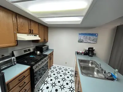 a small kitchen with a sink and a stove at The Meadows- Charmed Ski & Relax Studio in Kirkwood