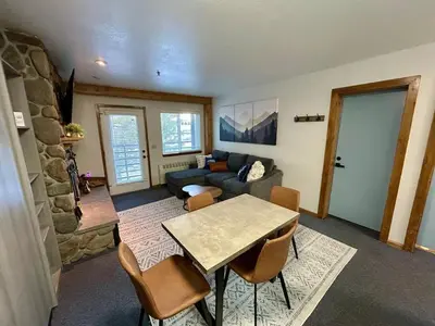 a living room with a table and a couch at The Meadows- Charmed Ski & Relax Studio in Kirkwood