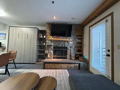 a living room with a fireplace and a television at The Meadows- Charming 1BD2BA Ski Condo in Kirkwood