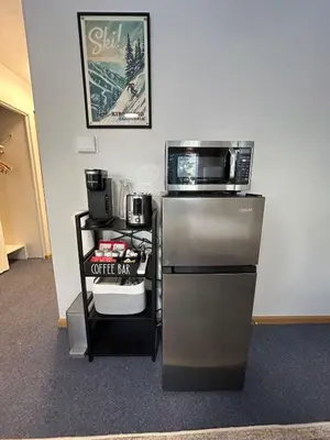a kitchen with a microwave and a coffee maker at The Meadows- Charming 1BD2BA Ski Condo in Kirkwood