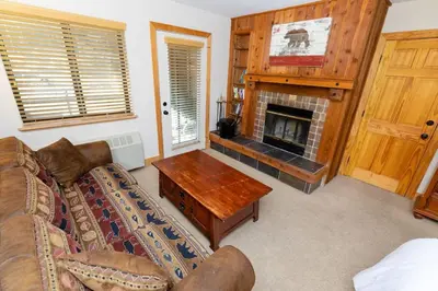 a living room with a couch and a fireplace at The Meadows - 2 Bdrm Family Condo in Kirkwood in Kirkwood