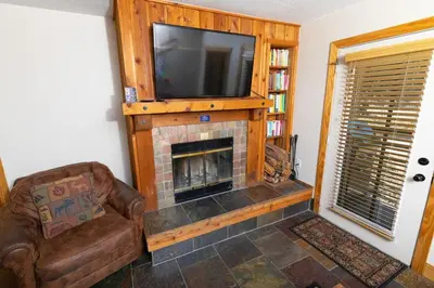 a living room with a fireplace with a flat screen tv at The Meadows - 2 Bdrm Family Condo in Kirkwood in Kirkwood