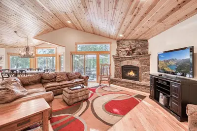 a living room with a couch and a fireplace at Kindred Pines at Tahoe Donner by Tahoe Getaways - 3BR with Pool Table & HOA in Truckee