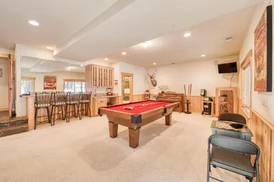 a room with a pool table and a bar at Kindred Pines at Tahoe Donner by Tahoe Getaways - 3BR with Pool Table & HOA in Truckee