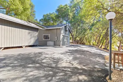 a house with a driveway next to a building at Game Room, 8 guests- Lake, Yosemite, Sonora nearby in Groveland