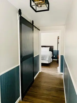 a door leading to a bedroom with a bed at Boulder Creek RV Resort in Lone Pine
