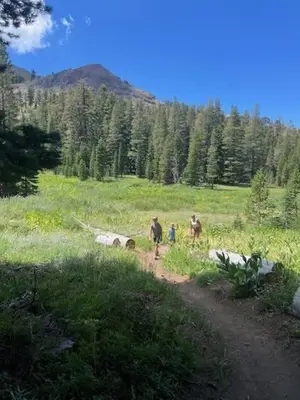 a group of people walking down a dirt road at Kirkwood Studio SKI IN Walk out in Kirkwood