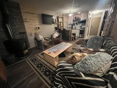 a living room with a couch and a table at Kirkwood Studio SKI IN Walk out in Kirkwood