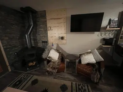 a living room with a couch and a fireplace at Kirkwood Studio SKI IN Walk out in Kirkwood